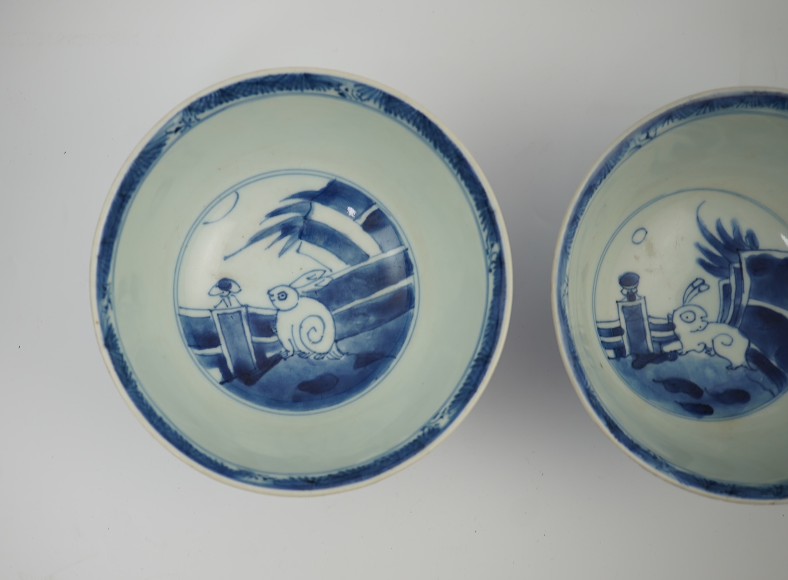 A pair of Chinese Transitional blue and white 'mythical beasts' bowls, early Kangxi period